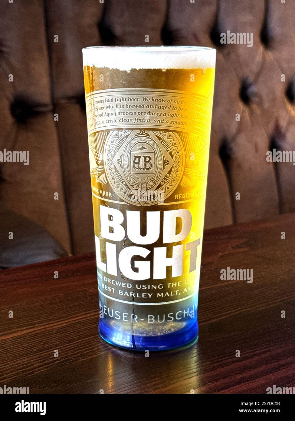Pint of Bud Light lager on the table of a bar. No people. - Smartphone Captured Stock Image