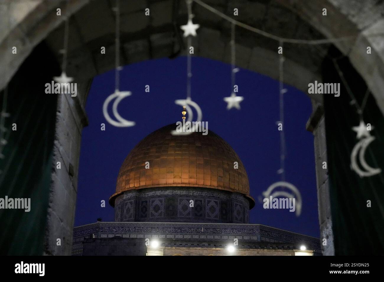 Holiday lights decorate a doorway near the Dome of the Rock Mosque in