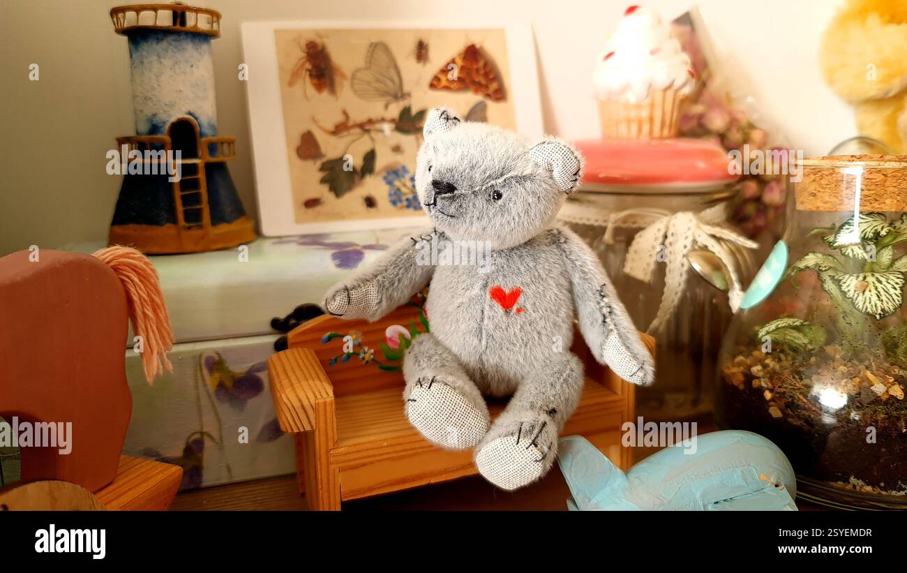 Handmade teddy bear is sitting on the bench Stock Photo