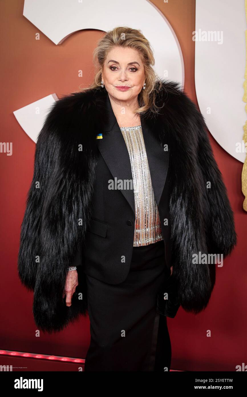 Catherine Deneuve poses as she arrives at the 50th Cesar Awards ...