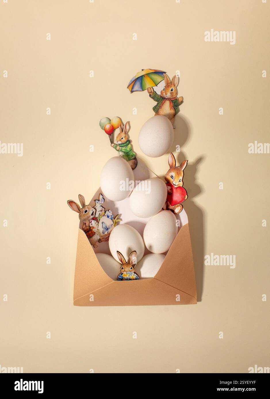 Eggs and bunnies in envelope. Creative layout, Easter card Stock Photo