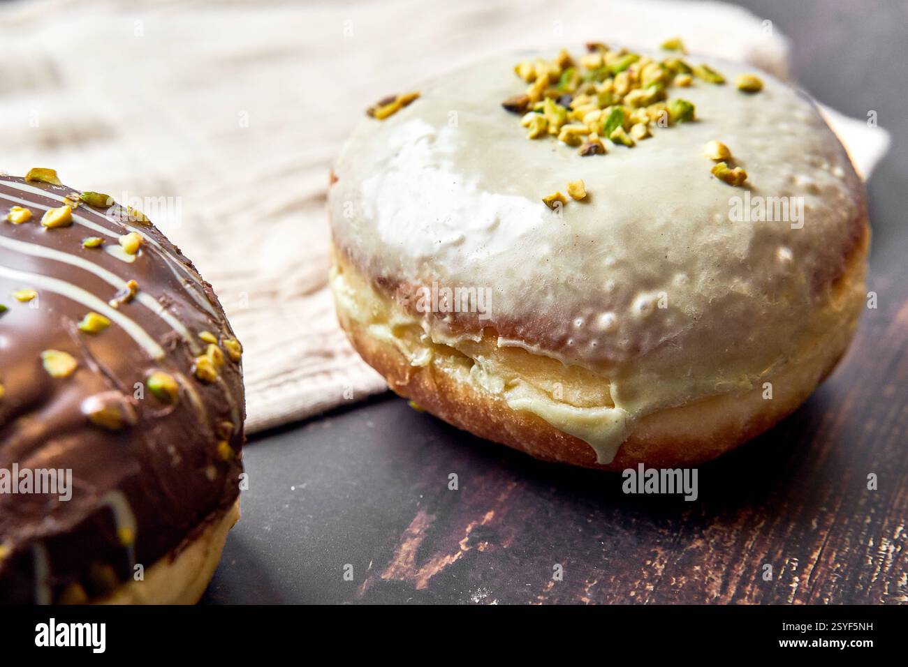 Germany - February 28, 2025: doughnuts with pistachio icing and chopped ...