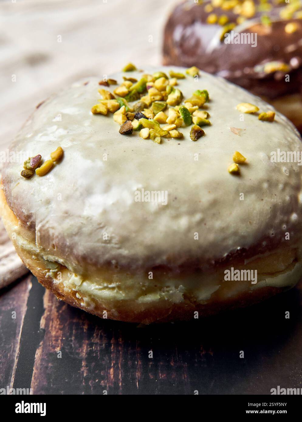 Germany - February 28, 2025: doughnuts with pistachio icing and chopped ...