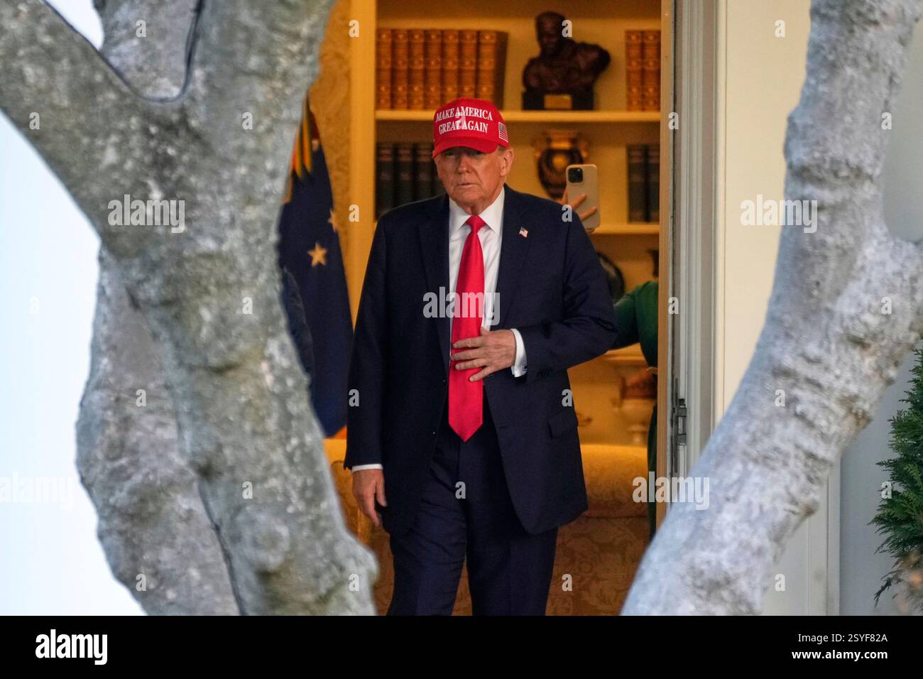 President Donald Trump walks from the Oval Office to depart on Marine ...