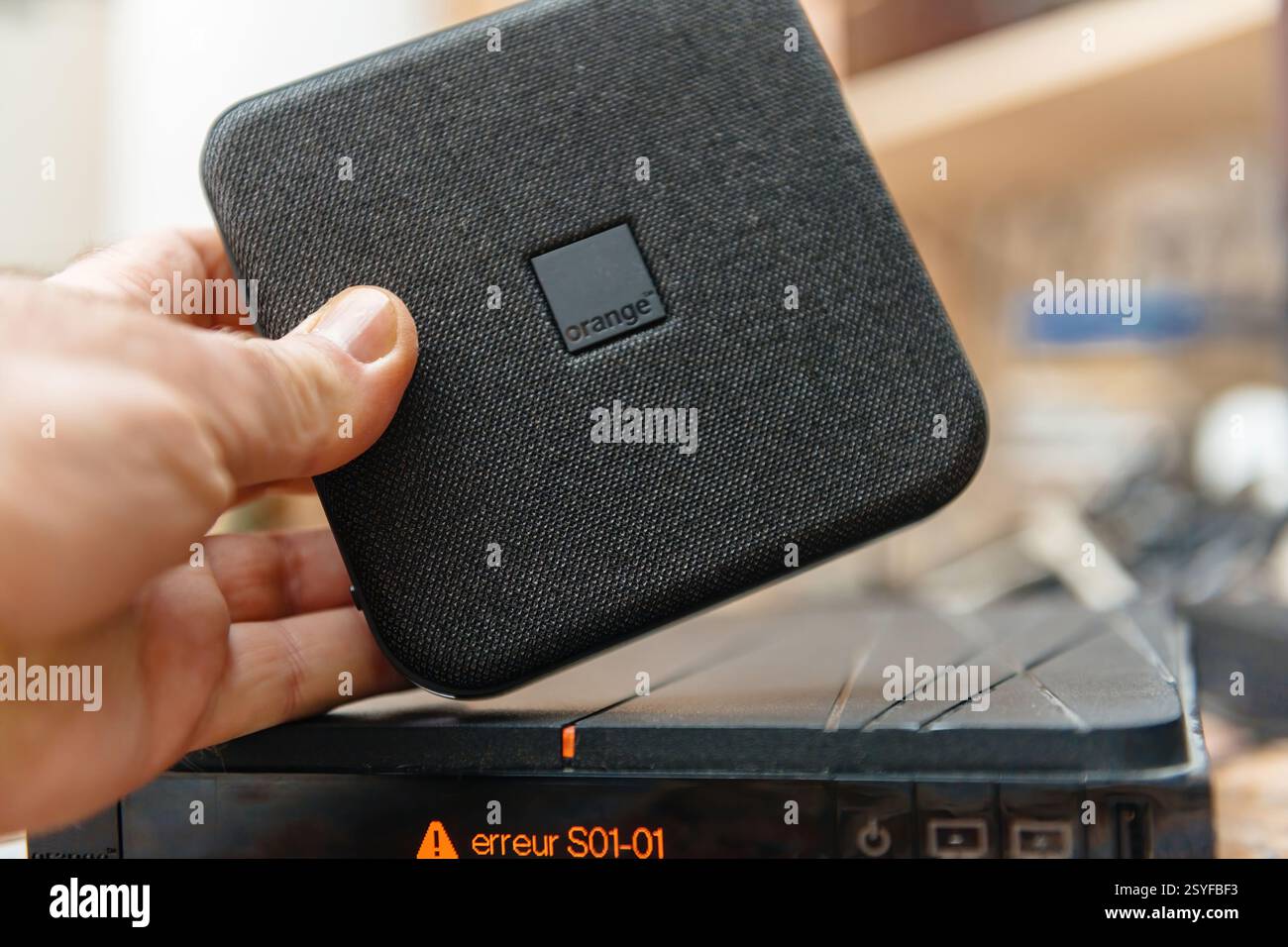 Paris, France - Feb 17, 2025: A person holds an Orange TV Decoder TV 6 ...