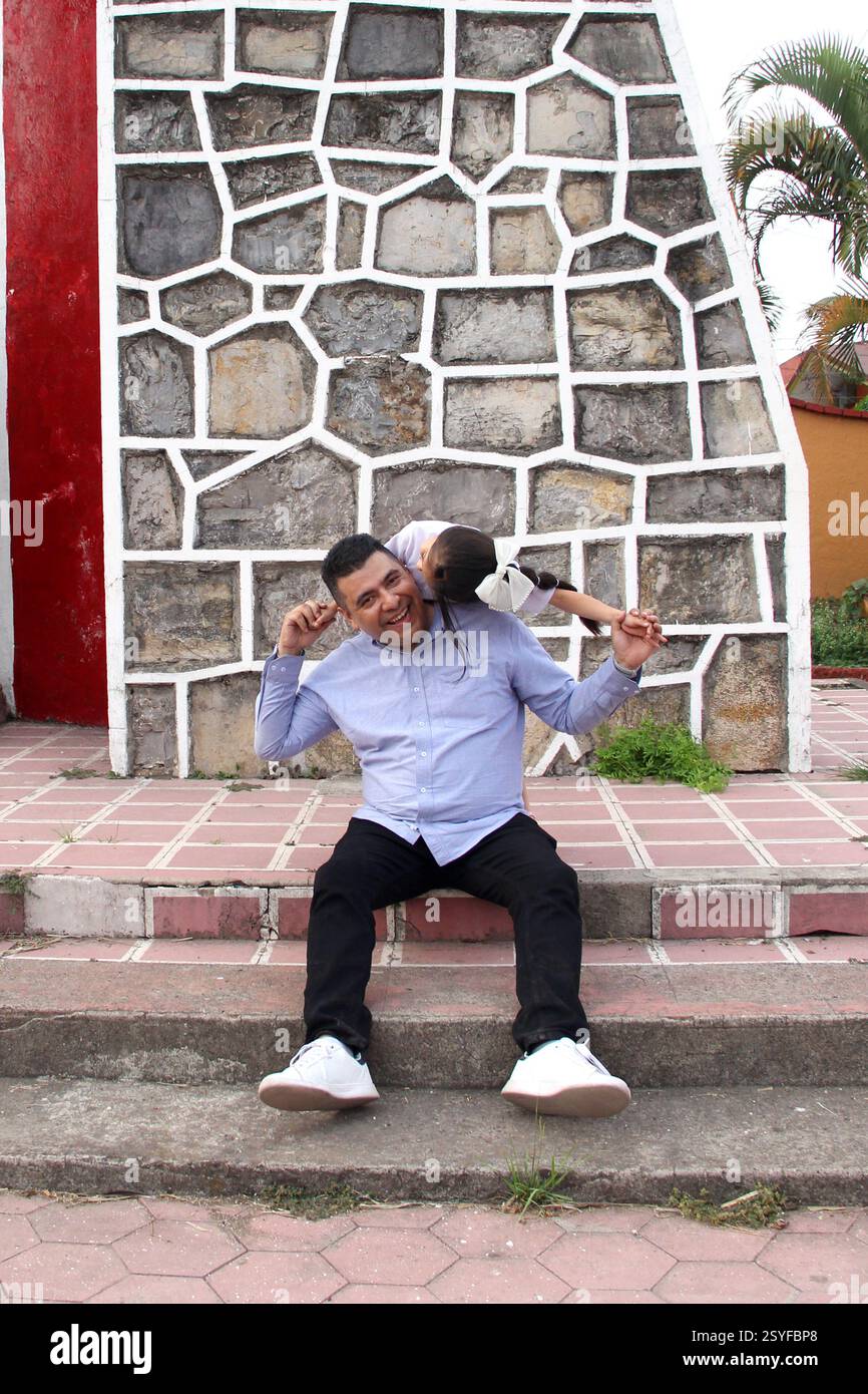 Pyggyback Style Divorced single dad carries his 5-year-old Latina daughter on his ...