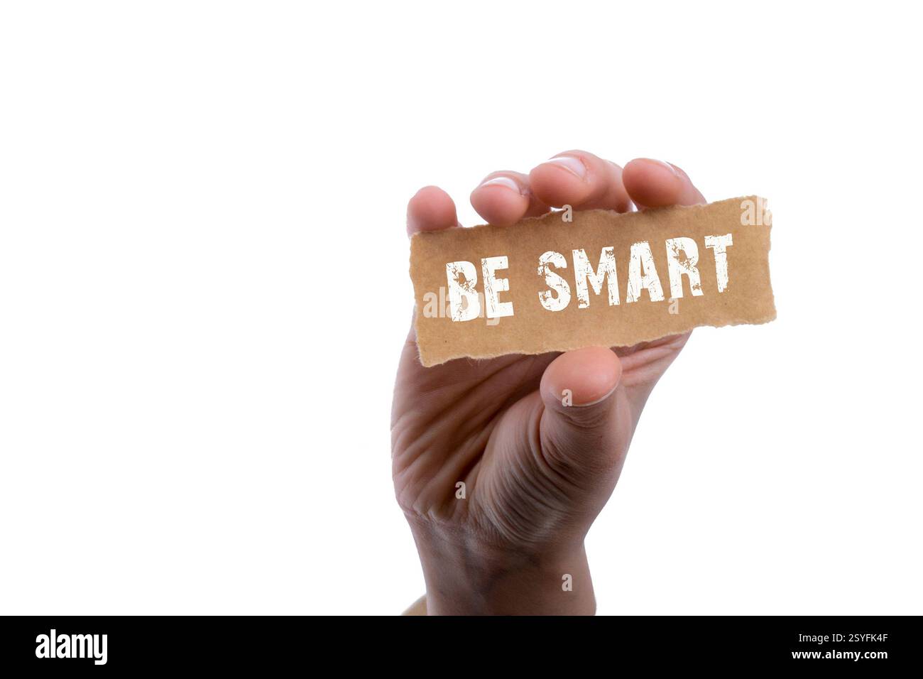 Hand holding torn notepaper with be smart word Stock Photo