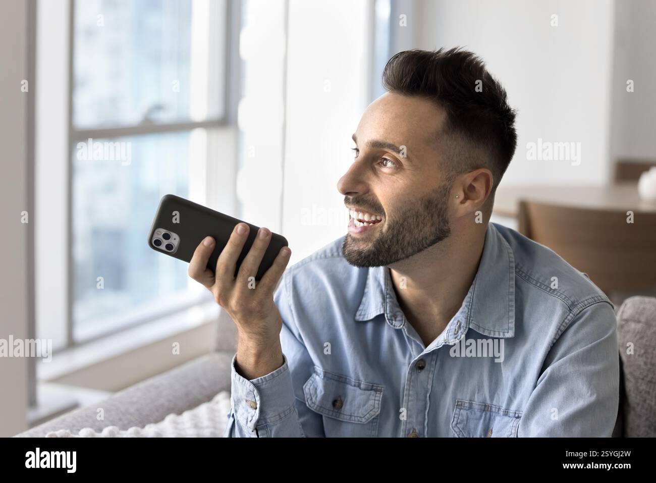 Man holding smartphone lead talk using speakerphone Stock Photo