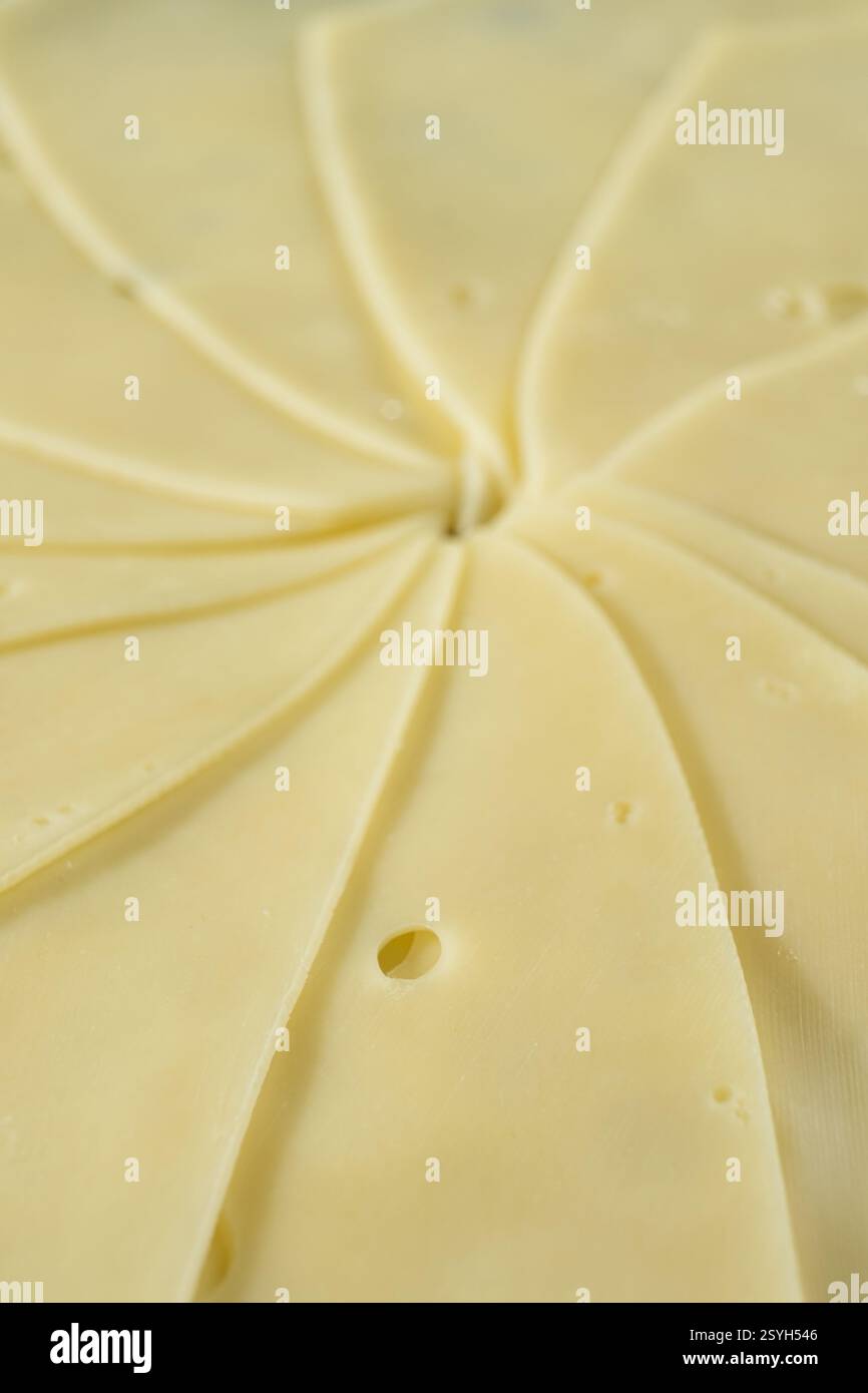 Semi-hard cheese close-up, thin slices. Stock Photo