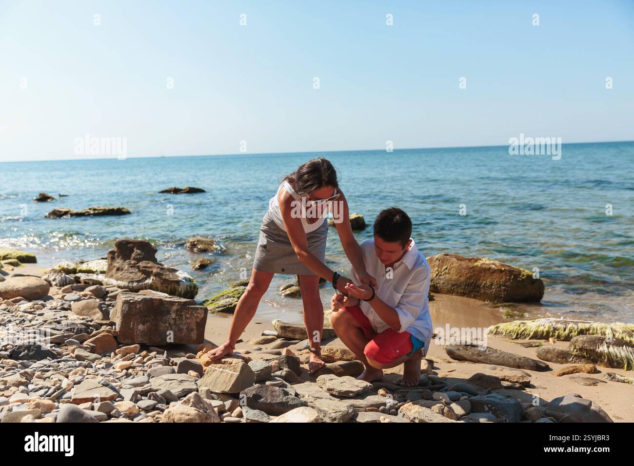 Person Collecting Rocks Collecting beach rocks hi-res stock photography and images - Alamy