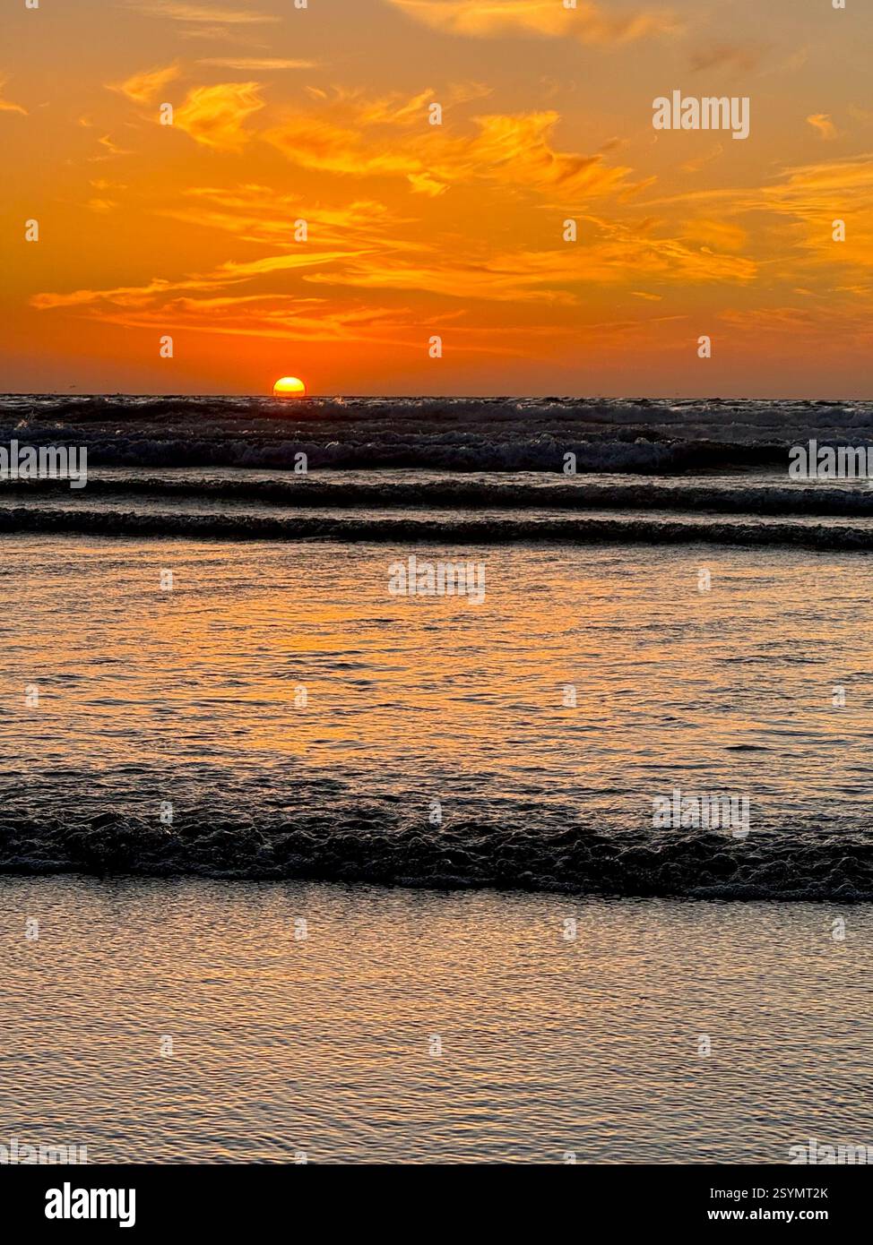 Agadir, Morocco, beach sunset with waves and orange sky. - Smartphone Captured Stock Image