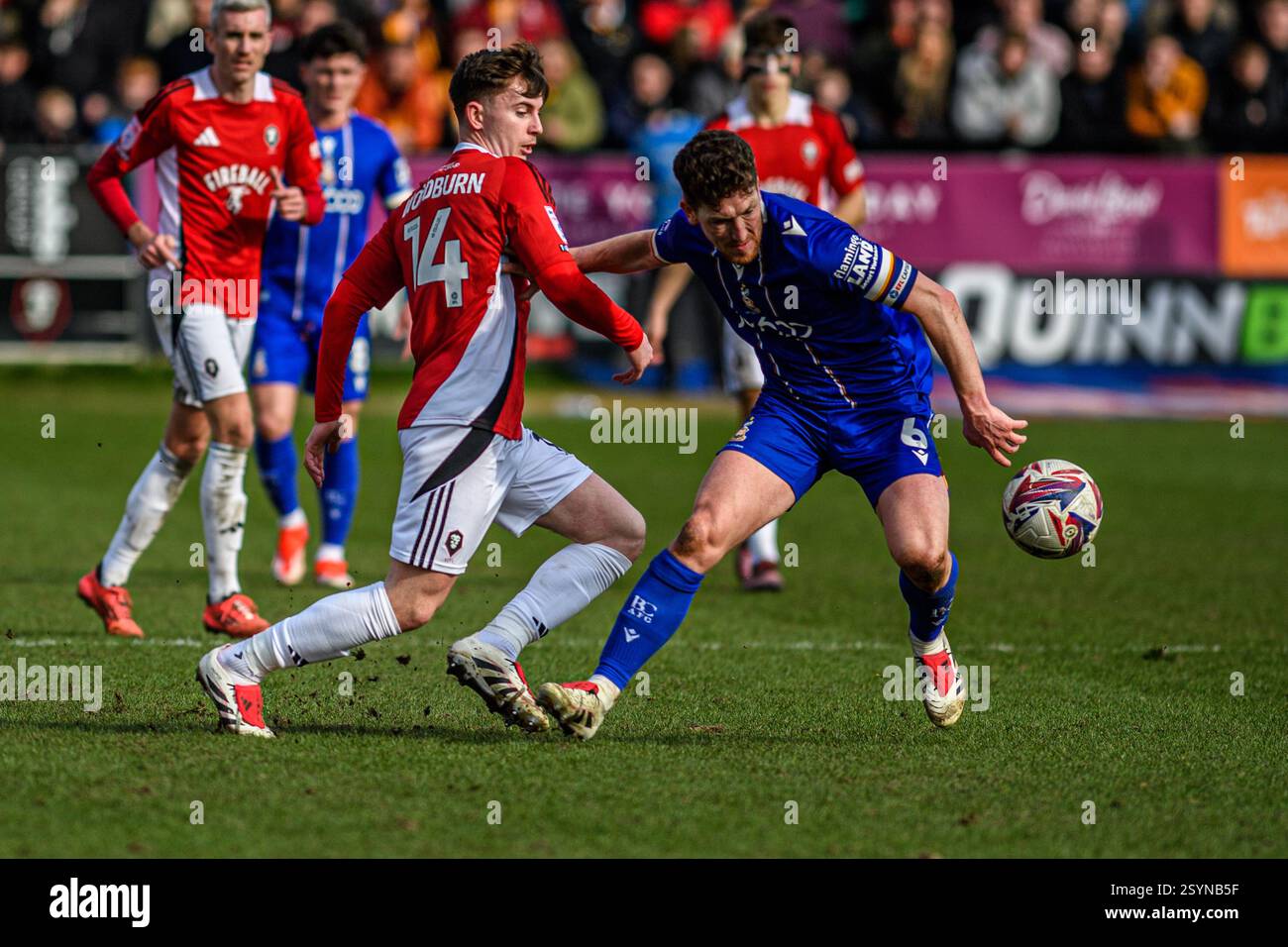 Will Wright of Salford City FC tackles Bradford City FC’s Richard