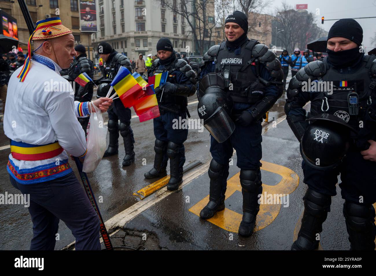 A man offers flags to riot policemen during a protest organized by the ...
