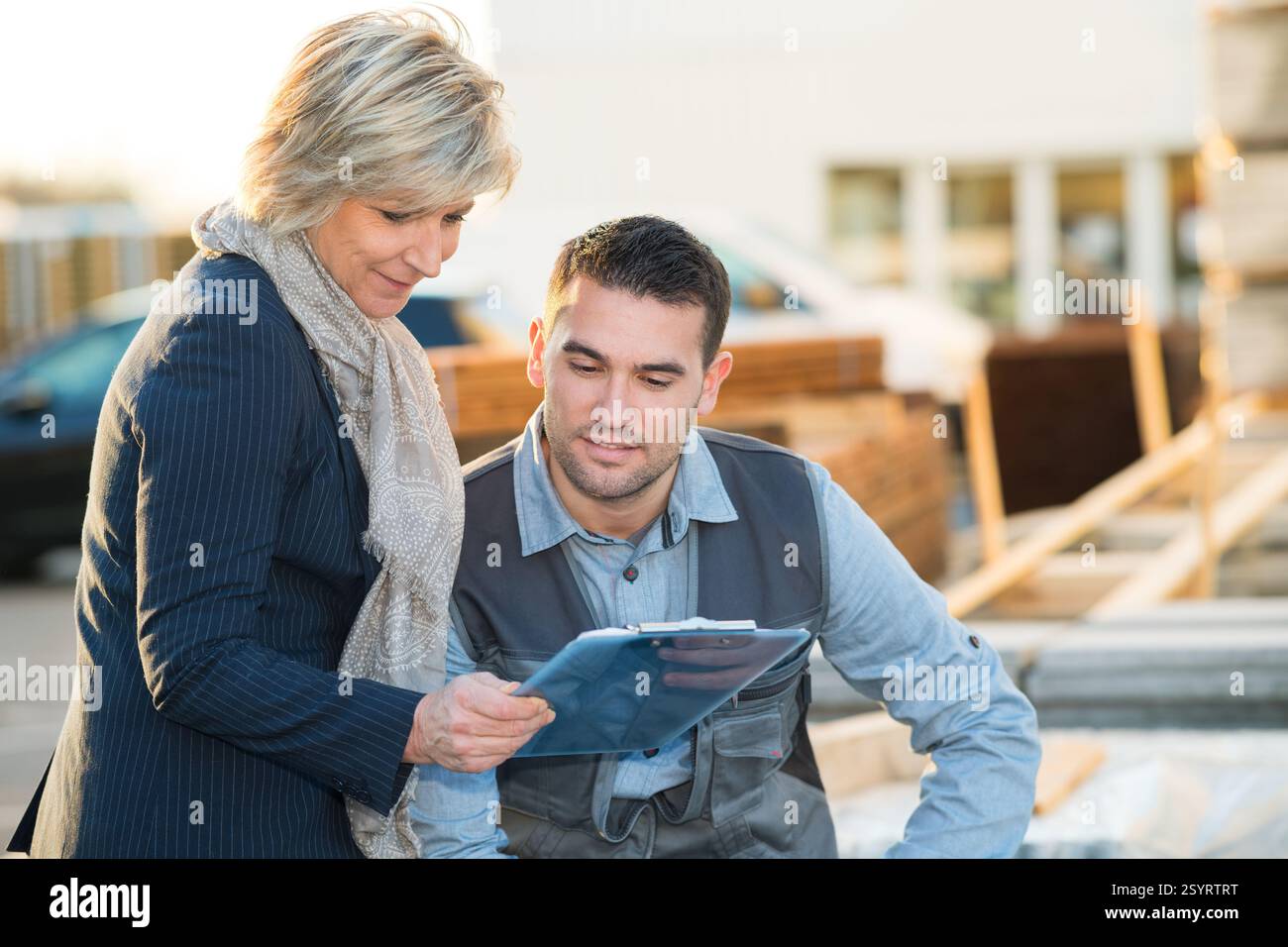 warehouse workers with clipboard discussing something Stock Photo