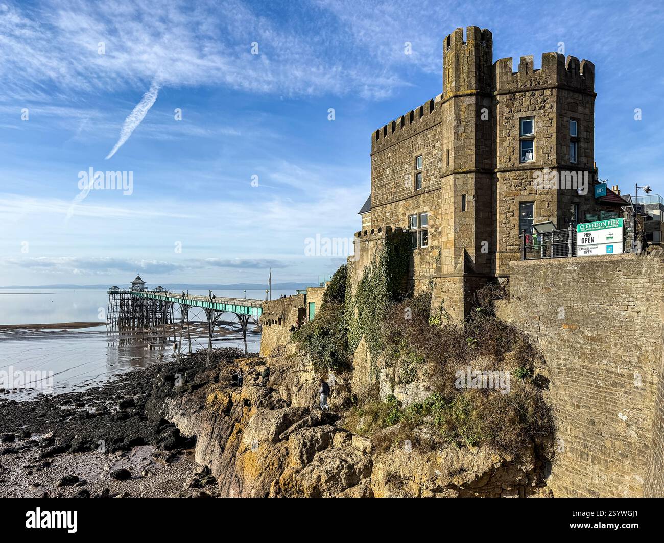 Visitors explore the cliffs near the open Clevedon Pier, a Grade 1 listed pier. - Smartphone Captured Stock Image