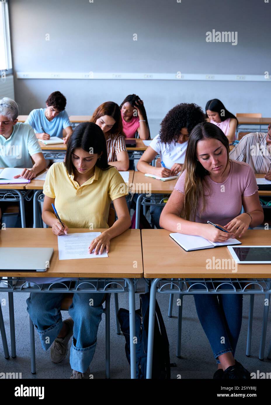 Front view of a group of multiracial students working together in a ...