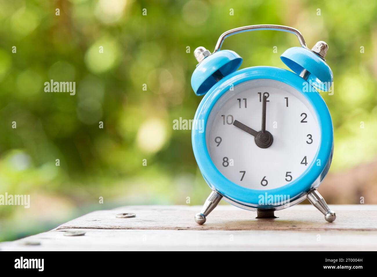 Blue and white Alarm clock on the wood table, Time and Schedule concept Stock Photo Alamy