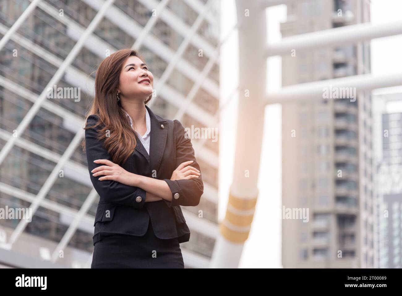Business woman thinking and look up for succeed in project. Happy life  and Business successful concept. Urban and outdoor Stock Photo