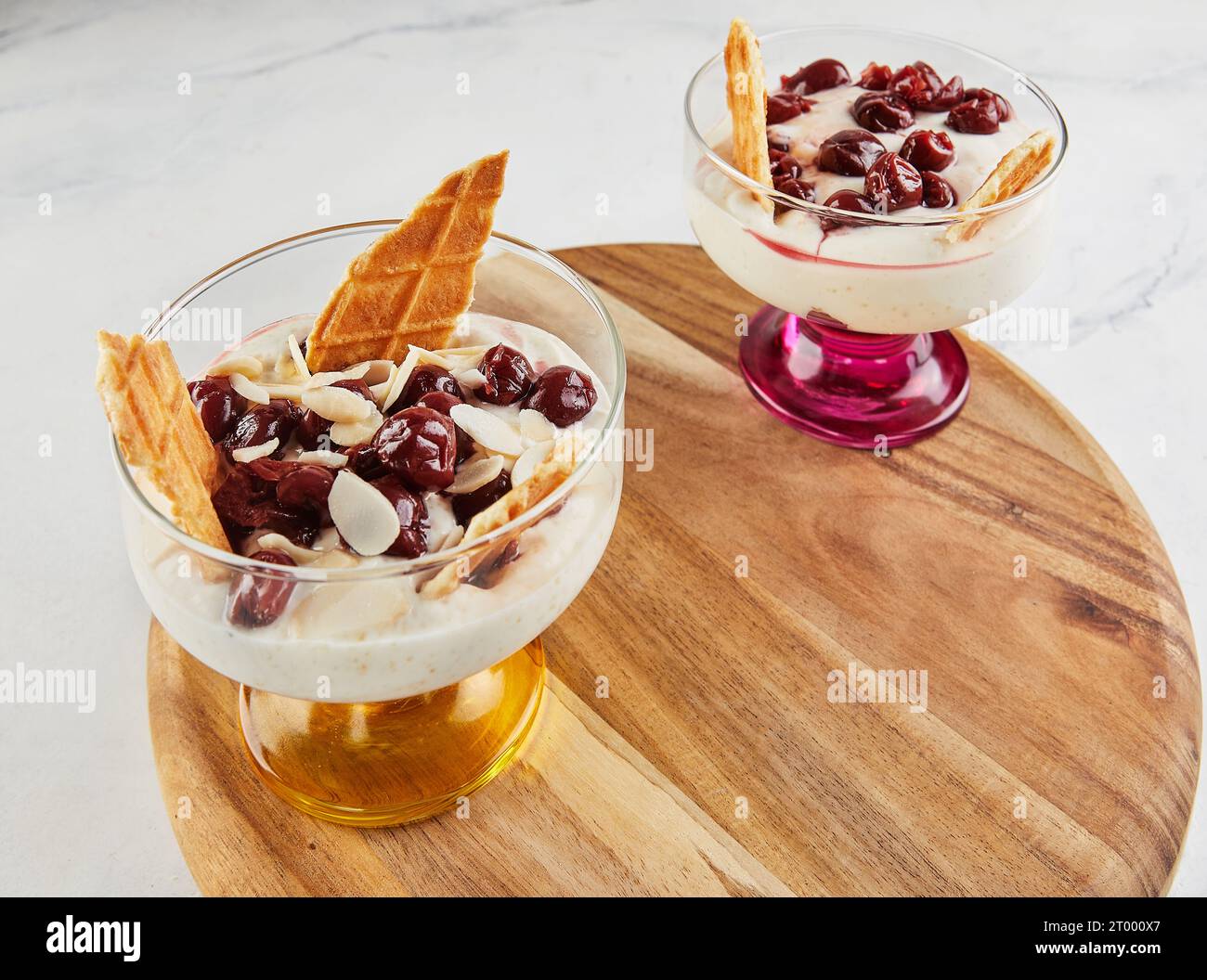 Cherries delicacy white cheese biscuits almond chips. Stock Photo