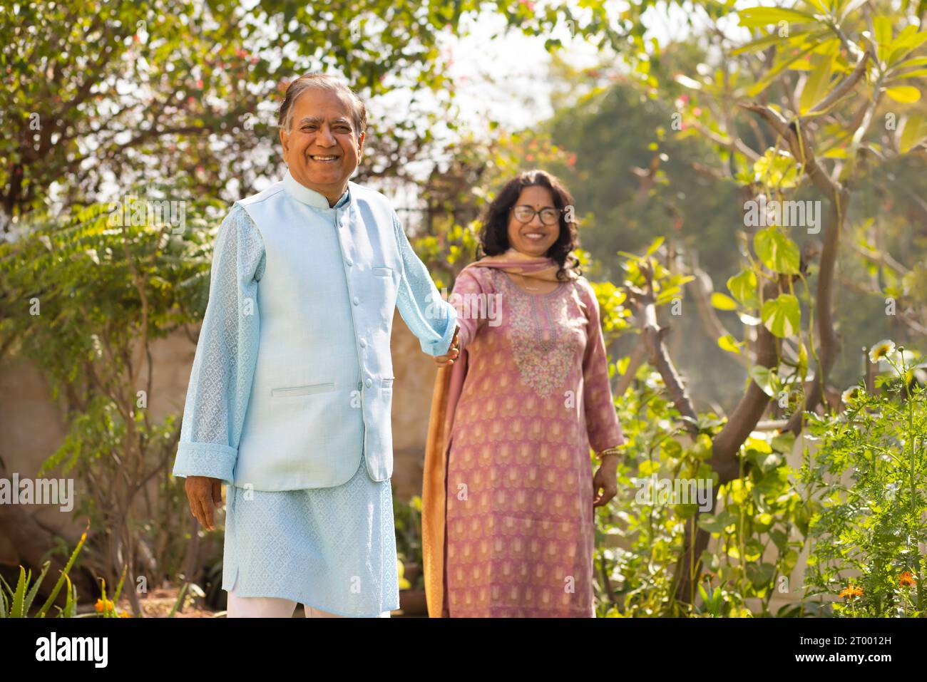Portrait of Mature couple holding their hands while standing in garden Stock Photo