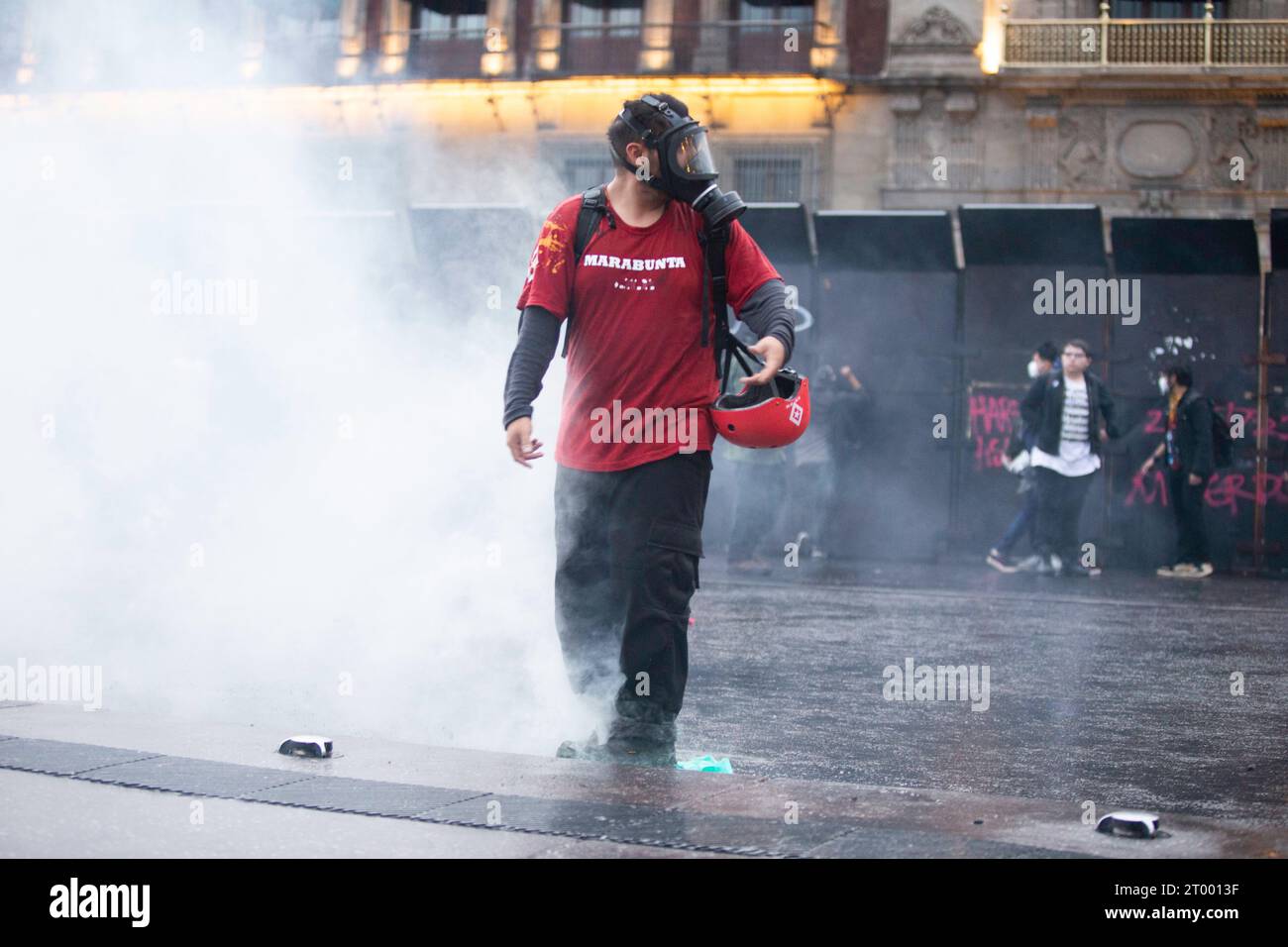 Mexico City, Mexico City, Mexico. 2nd Oct, 2023. Member of the civil protection, trying to extinguish a tear gas thrown by the government police during a protest on the anniversary of the Tlatelolco massacre. On October 2, 1968 in the Tlatelolco section of Mexico City, the Mexican Armed Forces opened fire on a group of unarmed civilians in the Plaza de las Tres Culturas who were protesting the upcoming 1968 Summer Olympics. (Credit Image: © Luis E Salgado/ZUMA Press Wire) EDITORIAL USAGE ONLY! Not for Commercial USAGE! Credit: ZUMA Press, Inc./Alamy Live News Stock Photo