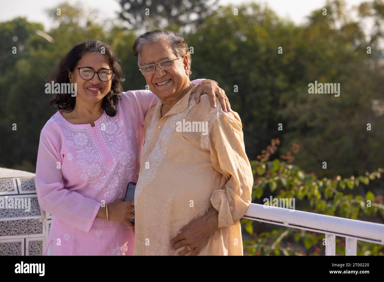 Portrait of happy Mature couple standing together on rooftop Stock Photo