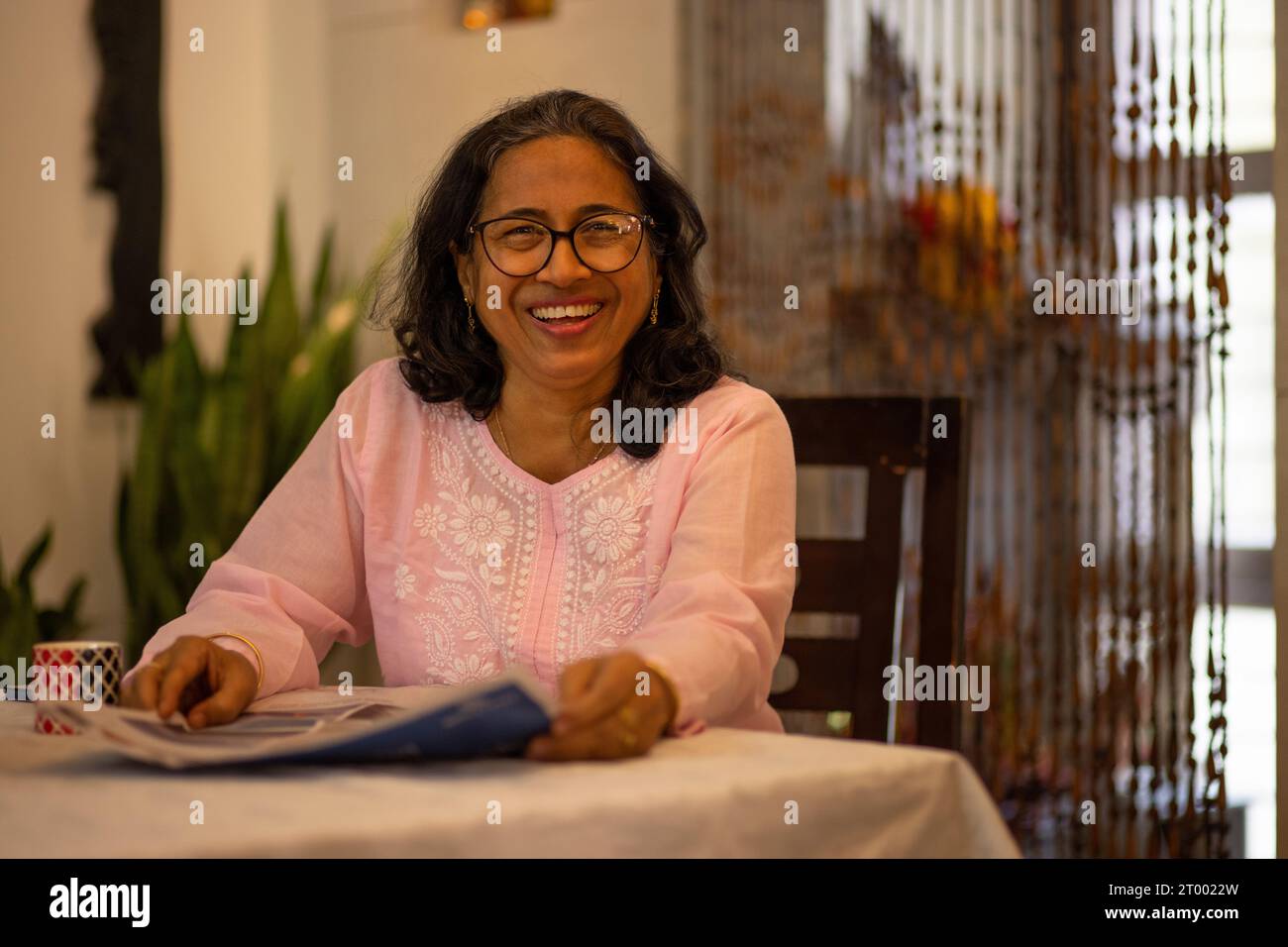 Indian woman reading newspaper hi-res stock photography and images - Alamy