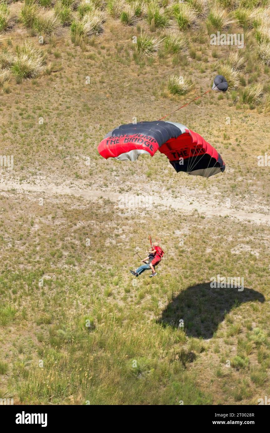 Tandem parachutists preparing to land. Stock Photo
