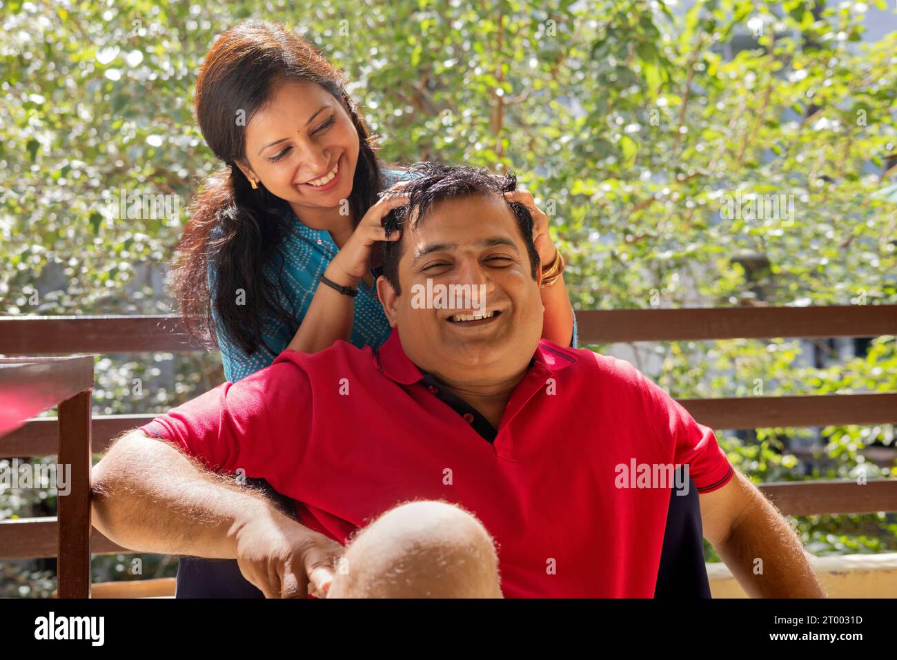 Woman Giving Head Message To Her Husband On Balcony Stock Photo Alamy