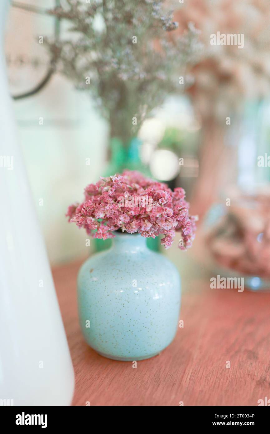 Home interior decor dried flowers in glass vase in Living room decoration. rustic brown wooden table restaurant cafe interior Stock Photo