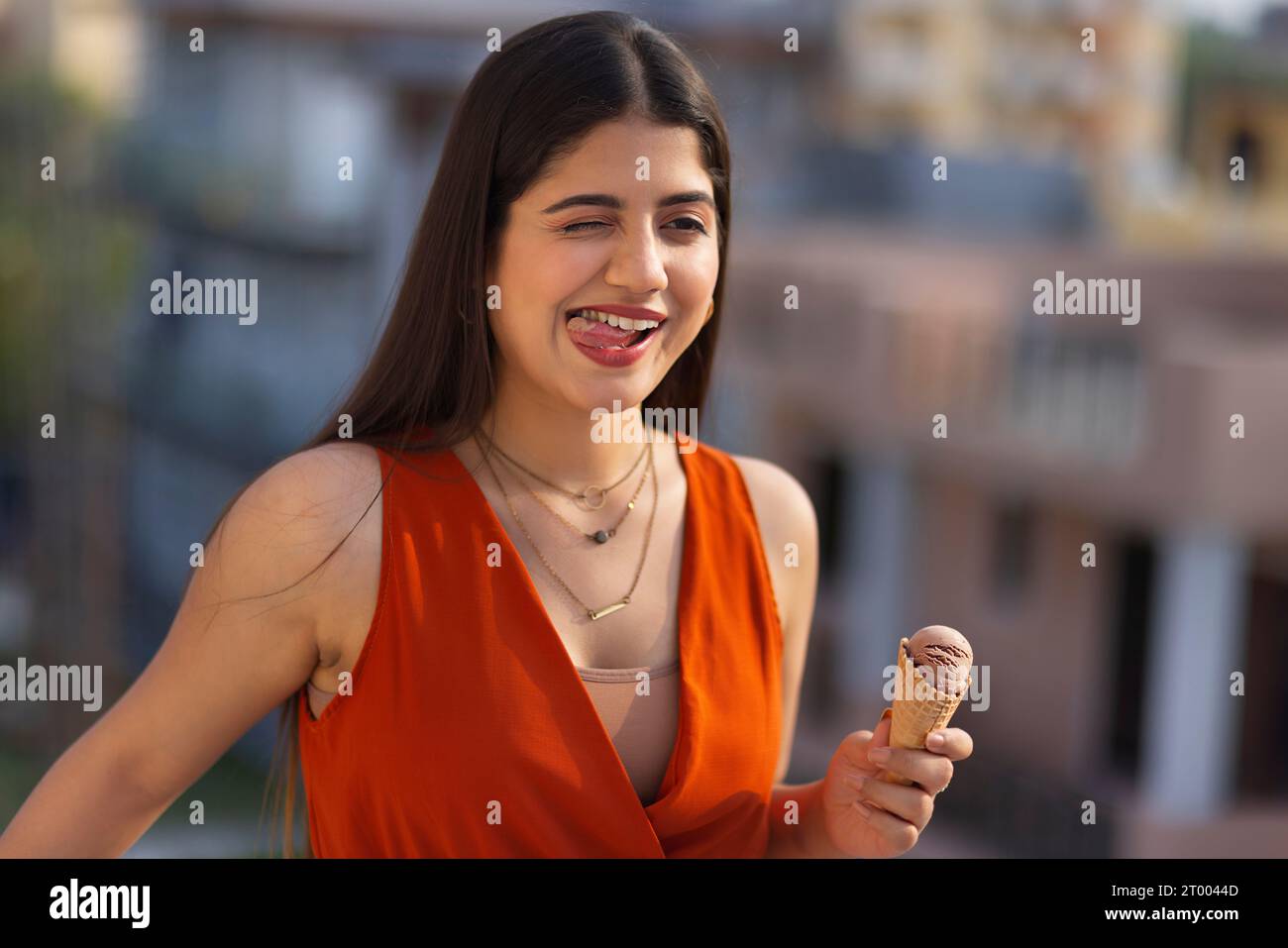 Portrait of young woman eating ice cream in cone Stock Photo