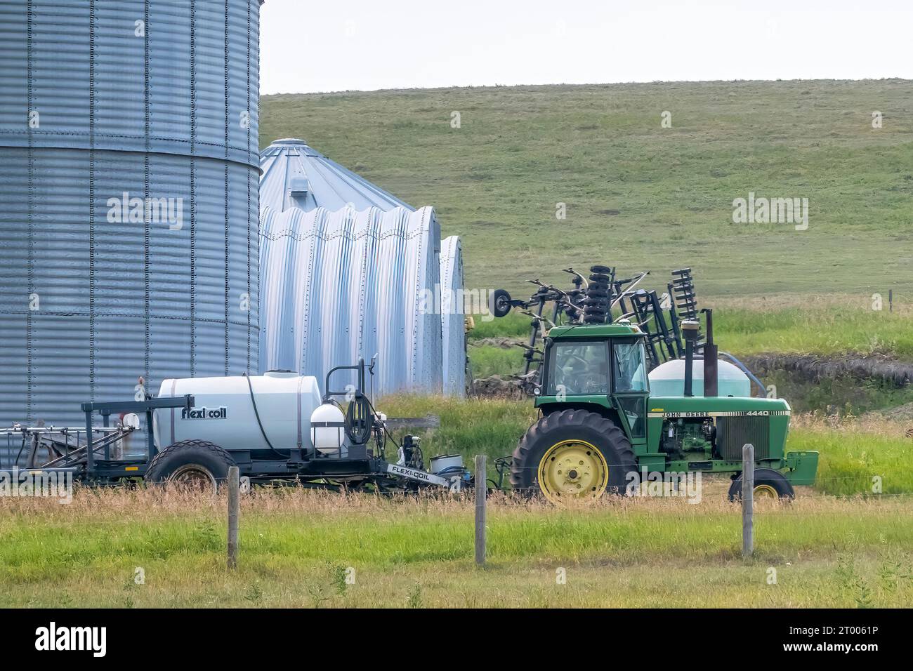 Calgary, Alberta, Canada. Aug 5, 2023. An agriculture tractor towing a pesticide container at a farm. Stock Photo