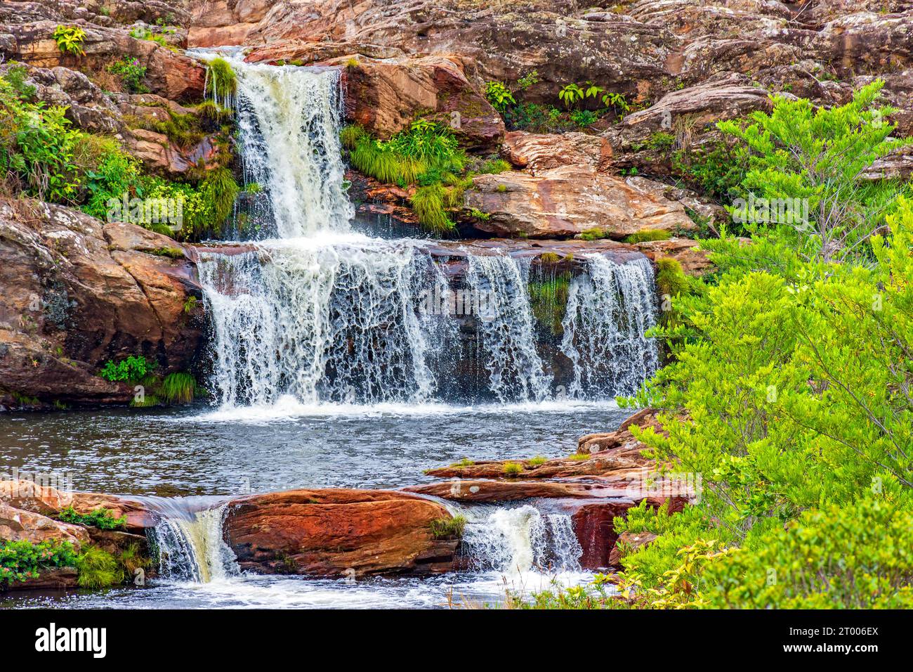 Small waterfalls among the rocks and vegetation Stock Photo - Alamy