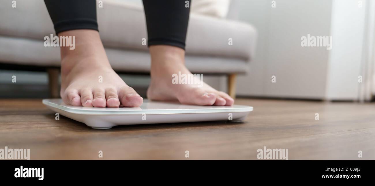 Women stand on electronic scales with measuring cables requiring weight  control. Woman foot stepping on weigh scales with tape measure. Diet  Concept 17154858 Stock Photo at Vecteezy