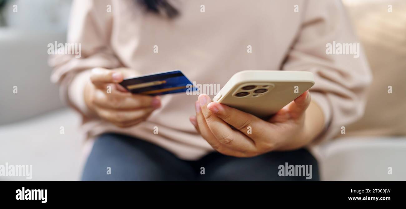 Senior woman with smart phone for online shopping.  Hand holding mobile phone with Payment on credit card online shopping electr Stock Photo