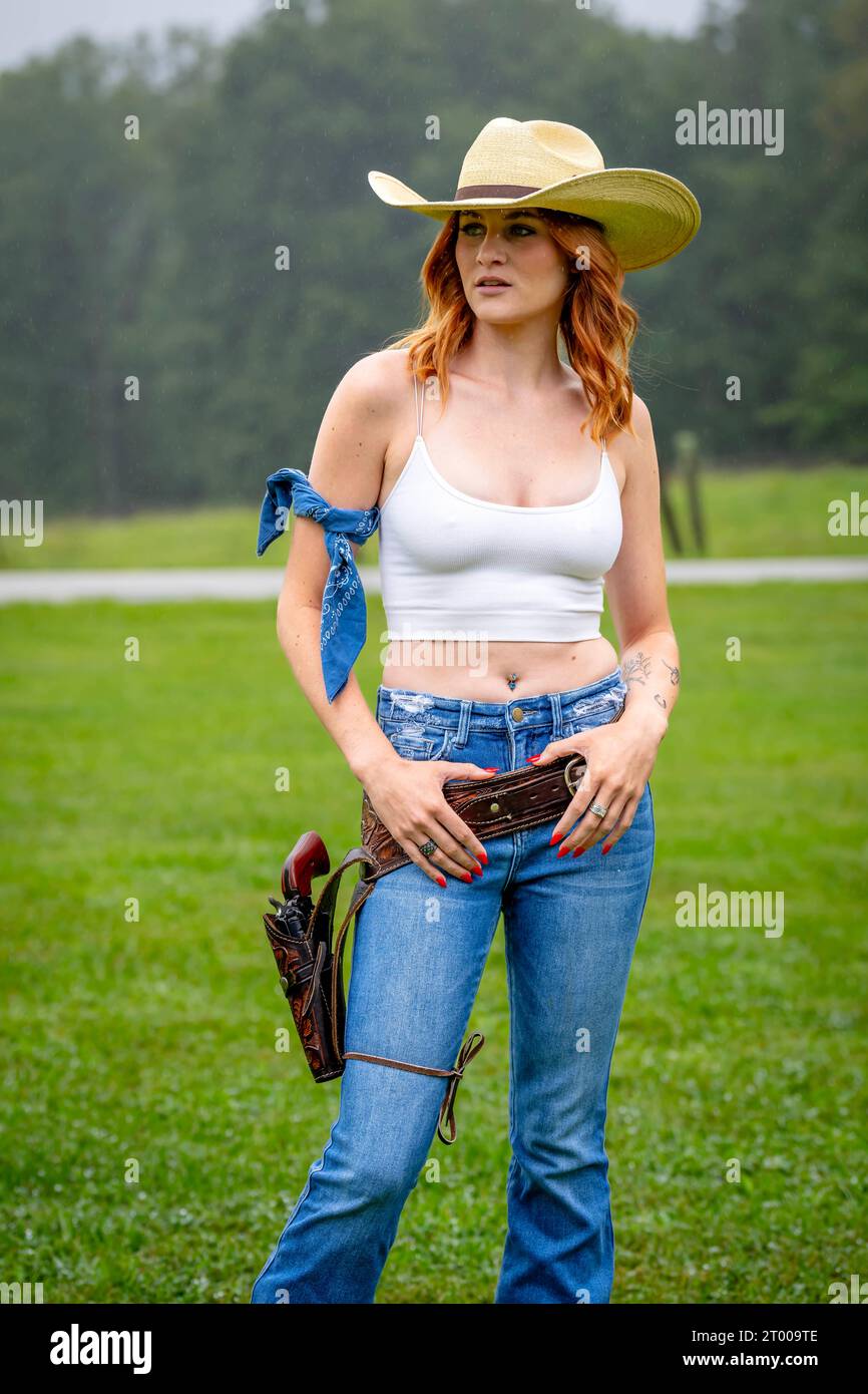 A Lovely Red Headed Country Wetern Model Poses Outdoors In A Country Setting Stock Photo