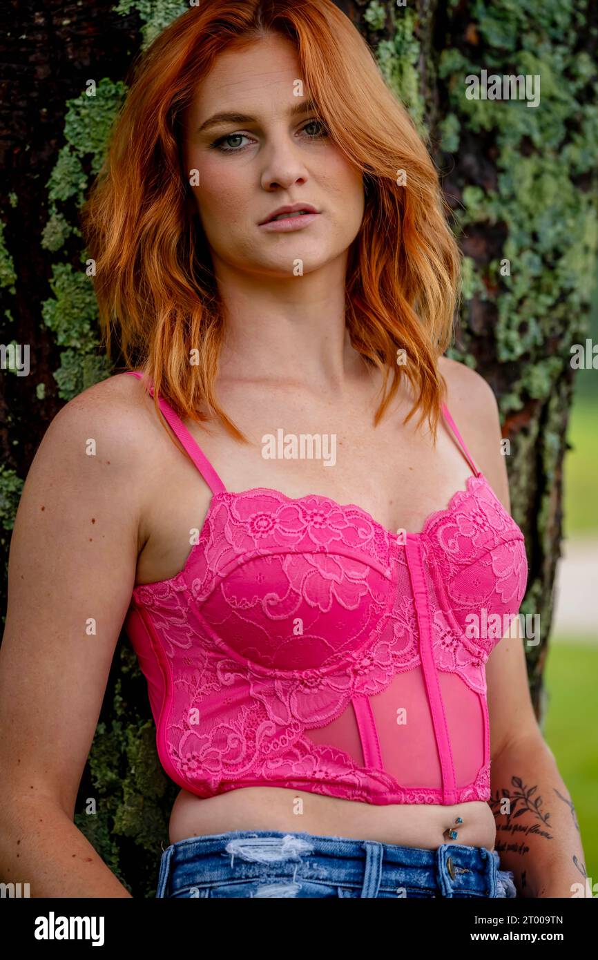 A Lovely Red Headed Country Wetern Model Poses Outdoors In A Country Setting Stock Photo