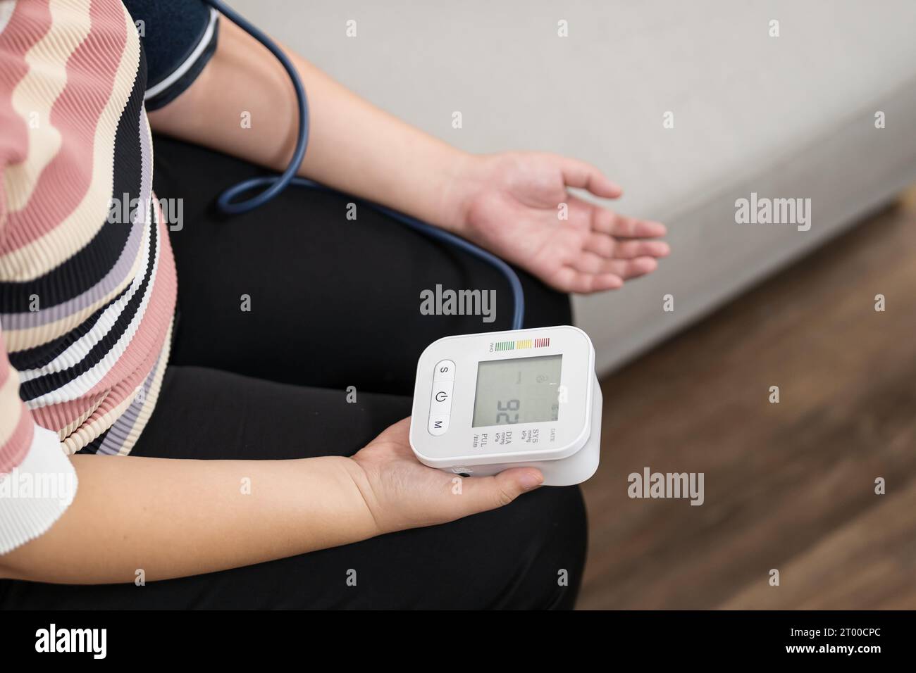 https://c8.alamy.com/comp/2T00CPC/woman-overweight-plus-size-self-checks-measuring-blood-pressure-and-heart-rate-tonometer-self-checkup-at-home-2T00CPC.jpg