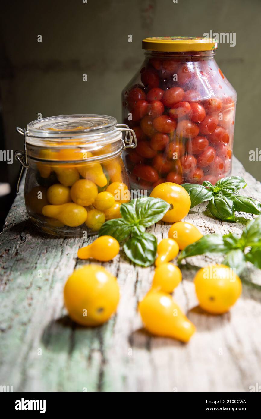 red and yellow cherry tomatoes in a jar for winter Stock Photo - Alamy