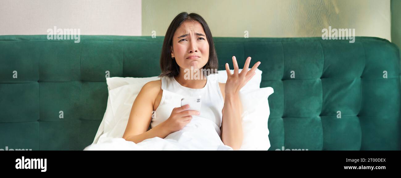 Asian woman crying in bed hi-res stock photography and images - Alamy