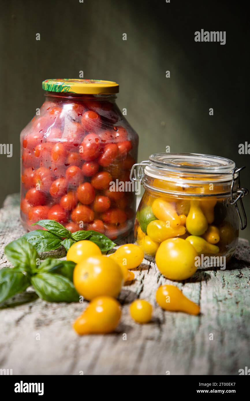 red and yellow cherry tomatoes in a jar for winter Stock Photo - Alamy