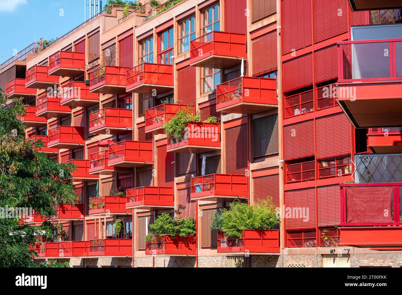 Modern red apartment building with balconies seen in Berlin, Germany