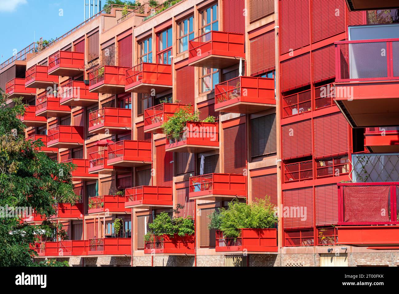 Modern red apartment building with balconies seen in Berlin, Germany Stock Photo