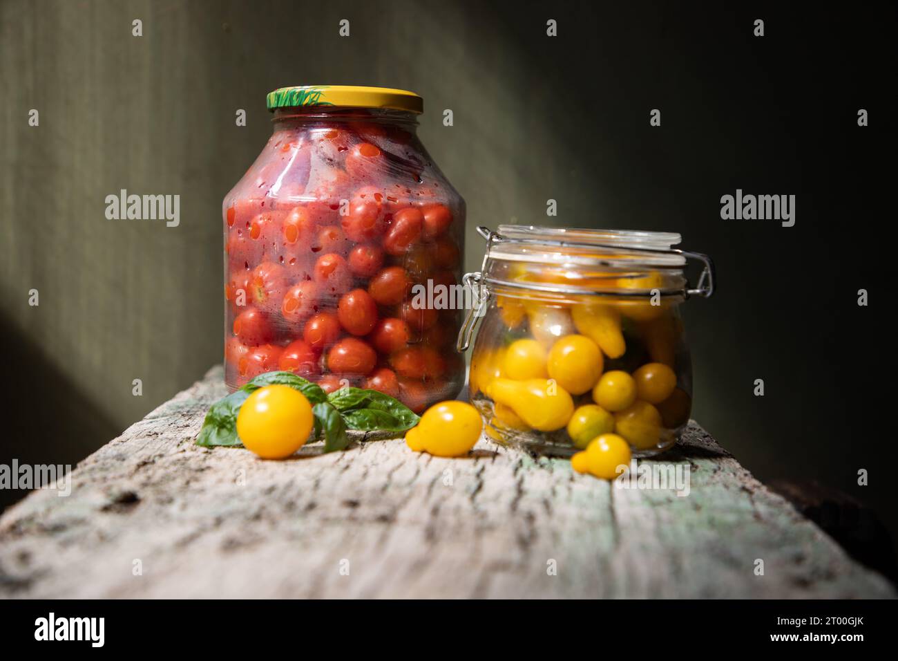 red and yellow cherry tomatoes in a jar for winter Stock Photo - Alamy