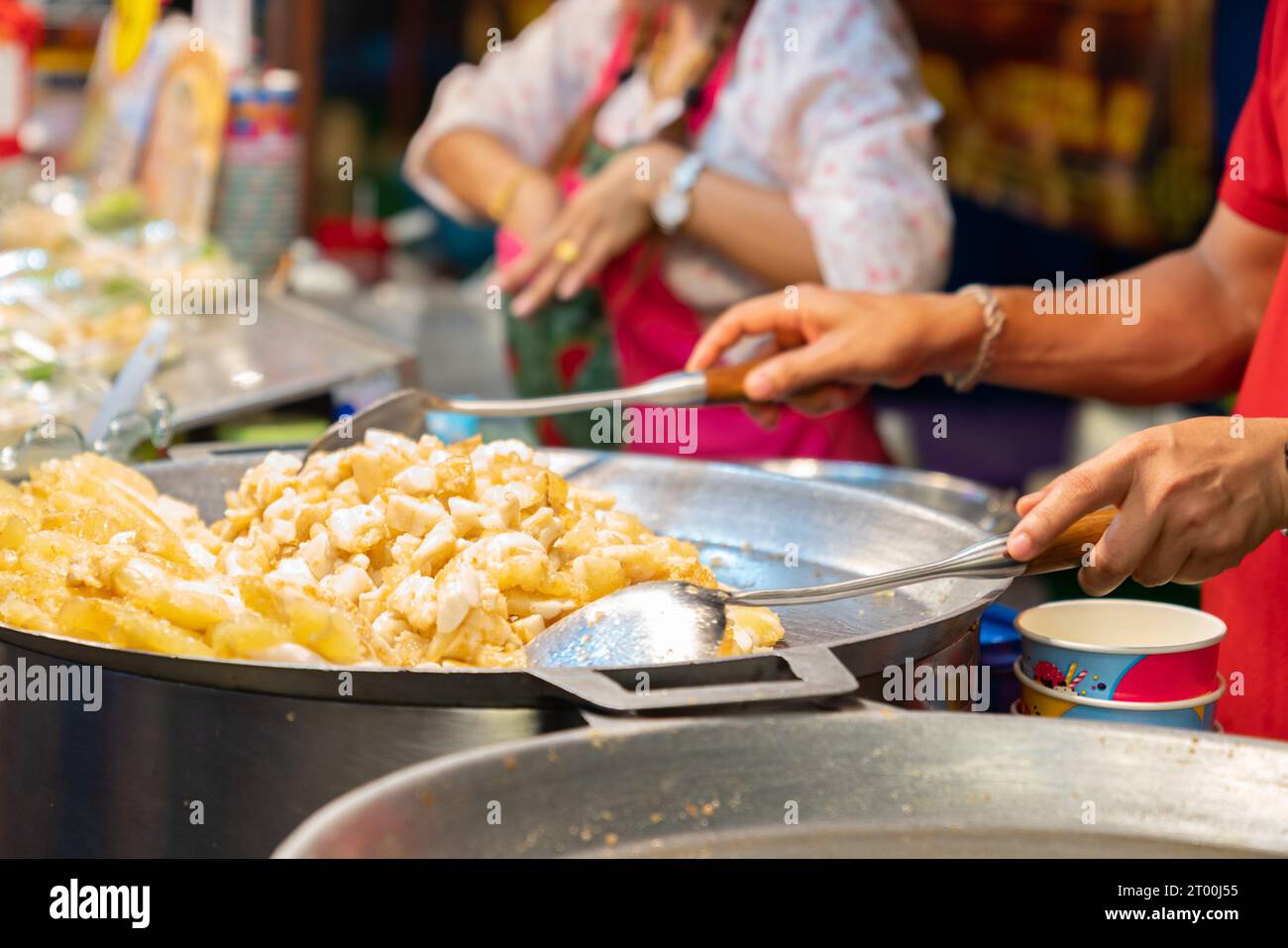 Fried squid eggs cooking in a large pan at street food market. Stock Photo
