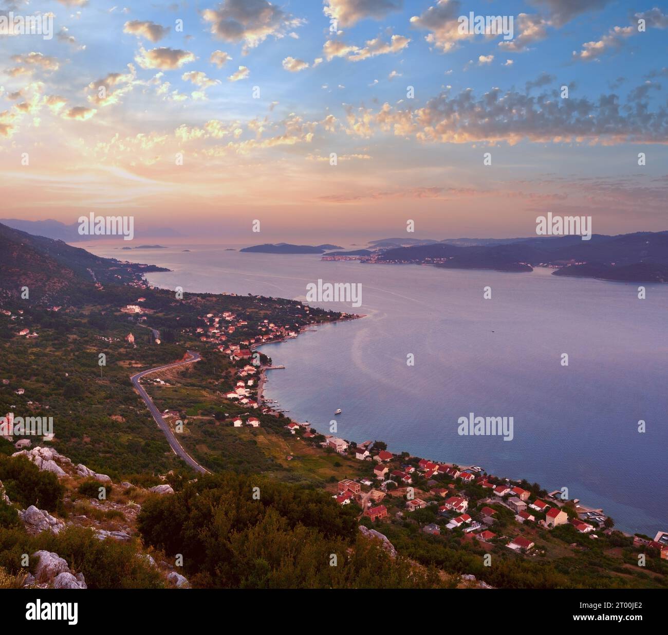 Sea sunset, Croatian islands and Viganj village on seashore (PeljeÑ–ac  peninsula, Croatia) and Korcula village and island in fa Stock Photo