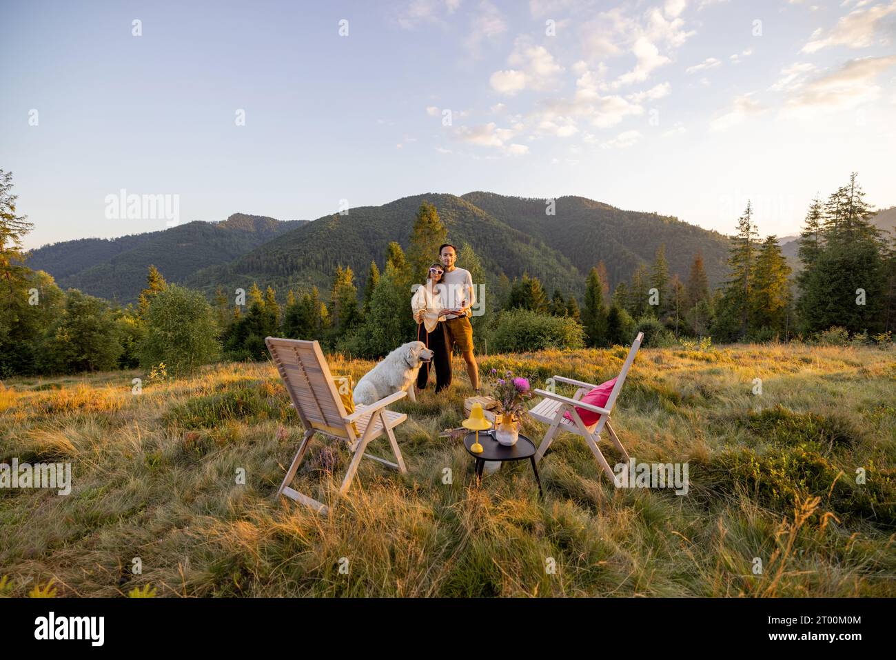 Man and woman have a picnic in mountains Stock Photo - Alamy