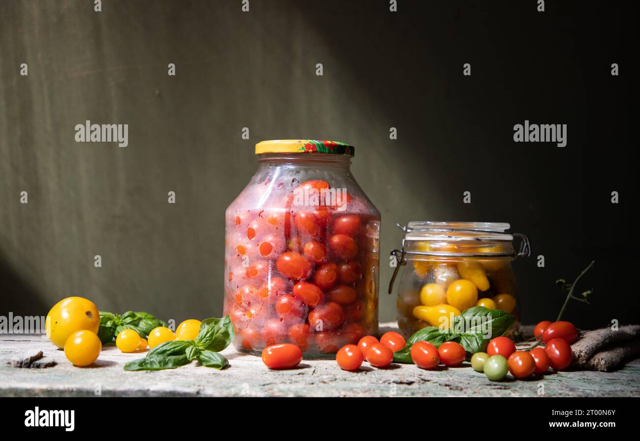 red and yellow cherry tomatoes in a jar for winter Stock Photo - Alamy