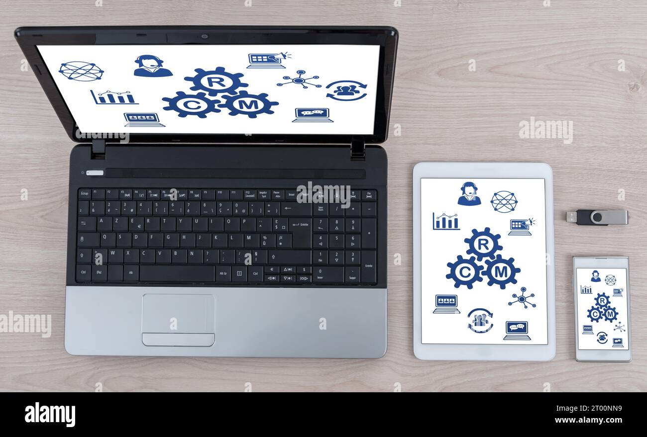 Crm concept shown on different information technology devices Stock Photo