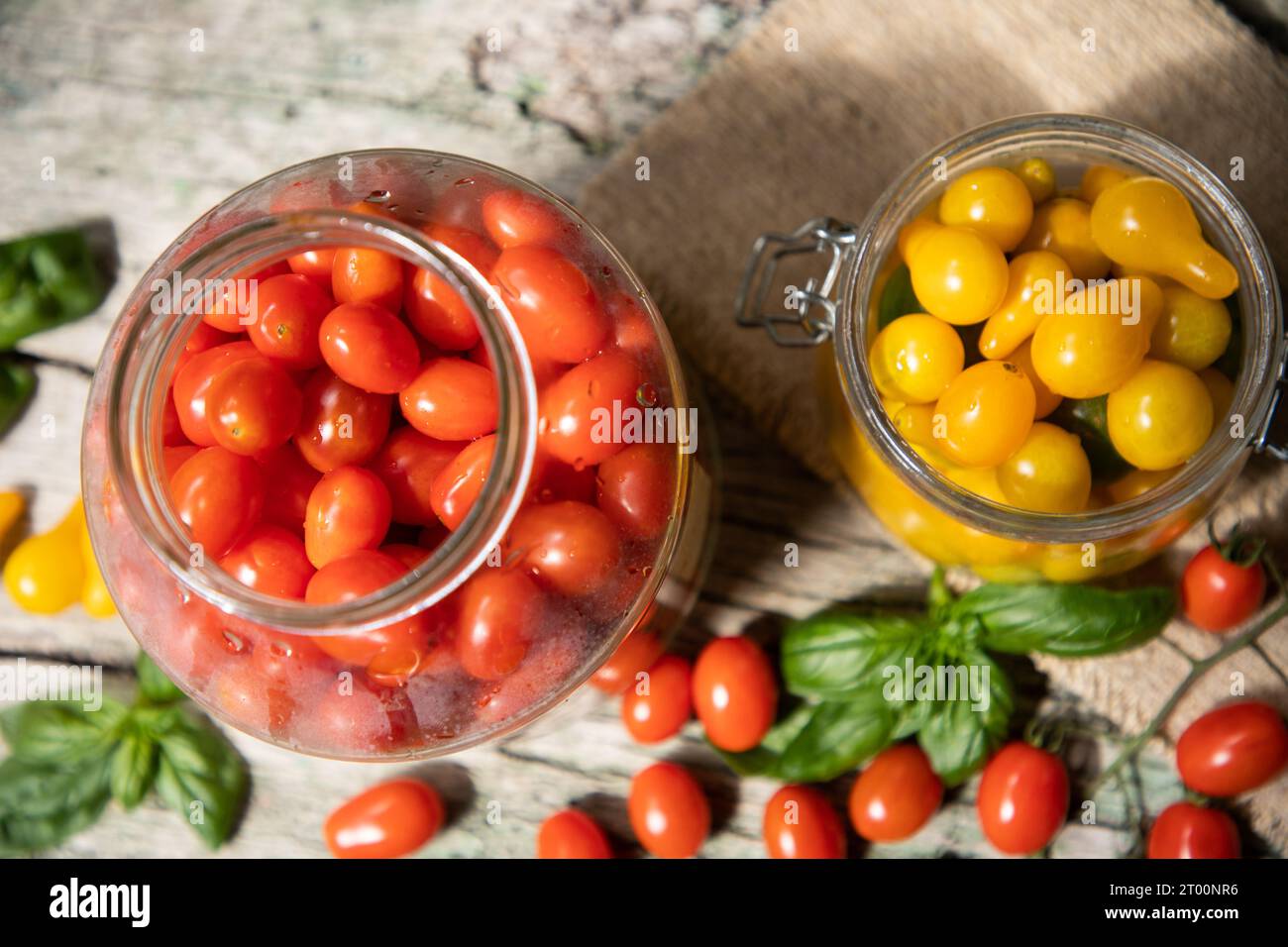 red and yellow cherry tomatoes in a jar for winter Stock Photo - Alamy